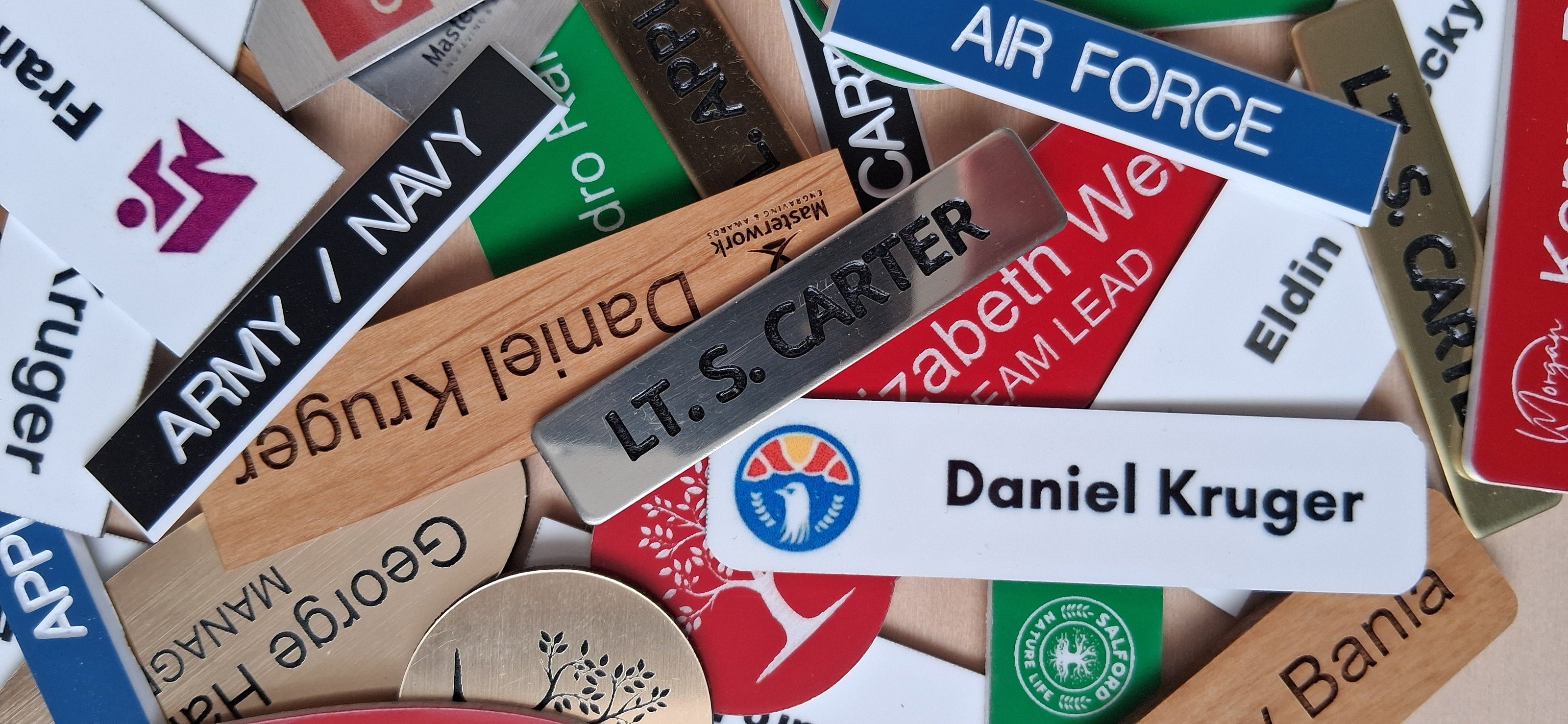 Collection of custom name tags made with various materials, designs and text.