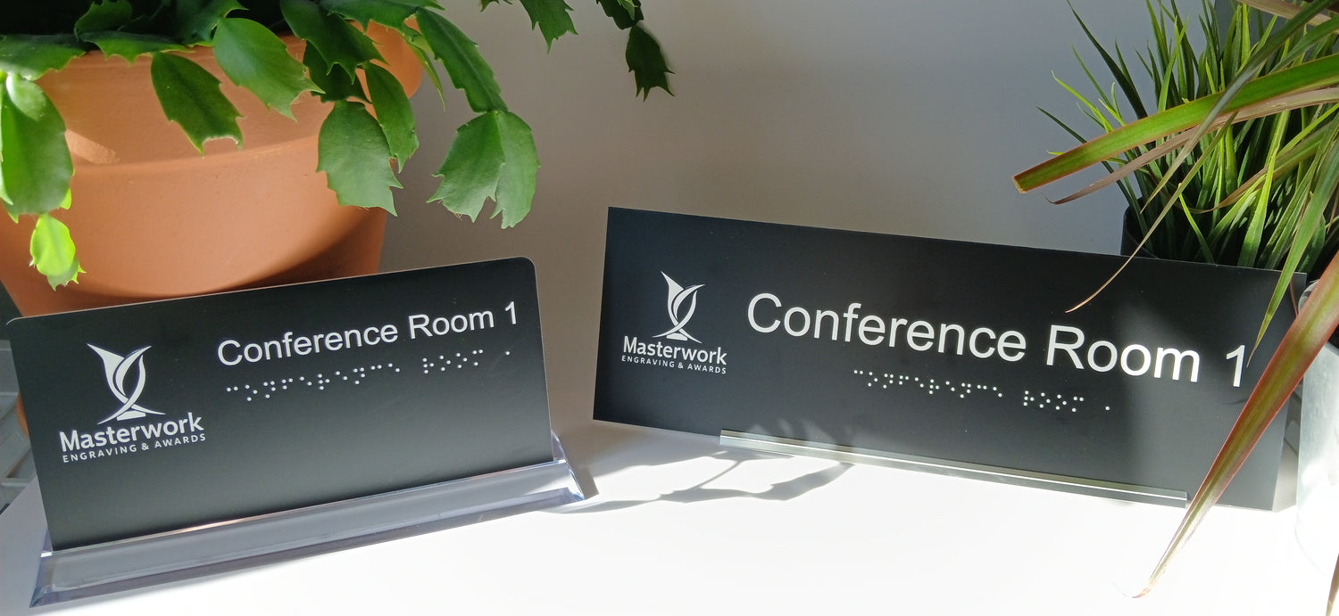 Office signs with braille and raised pictograms for ADA compliance 