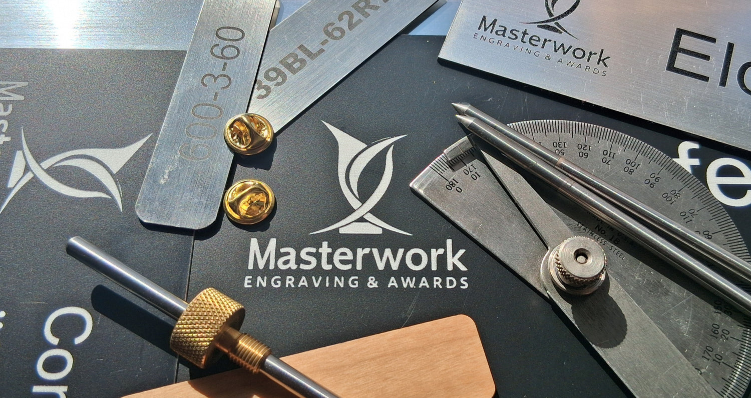 Engraving tools and equipment with Masterwork branding on a dark surface.