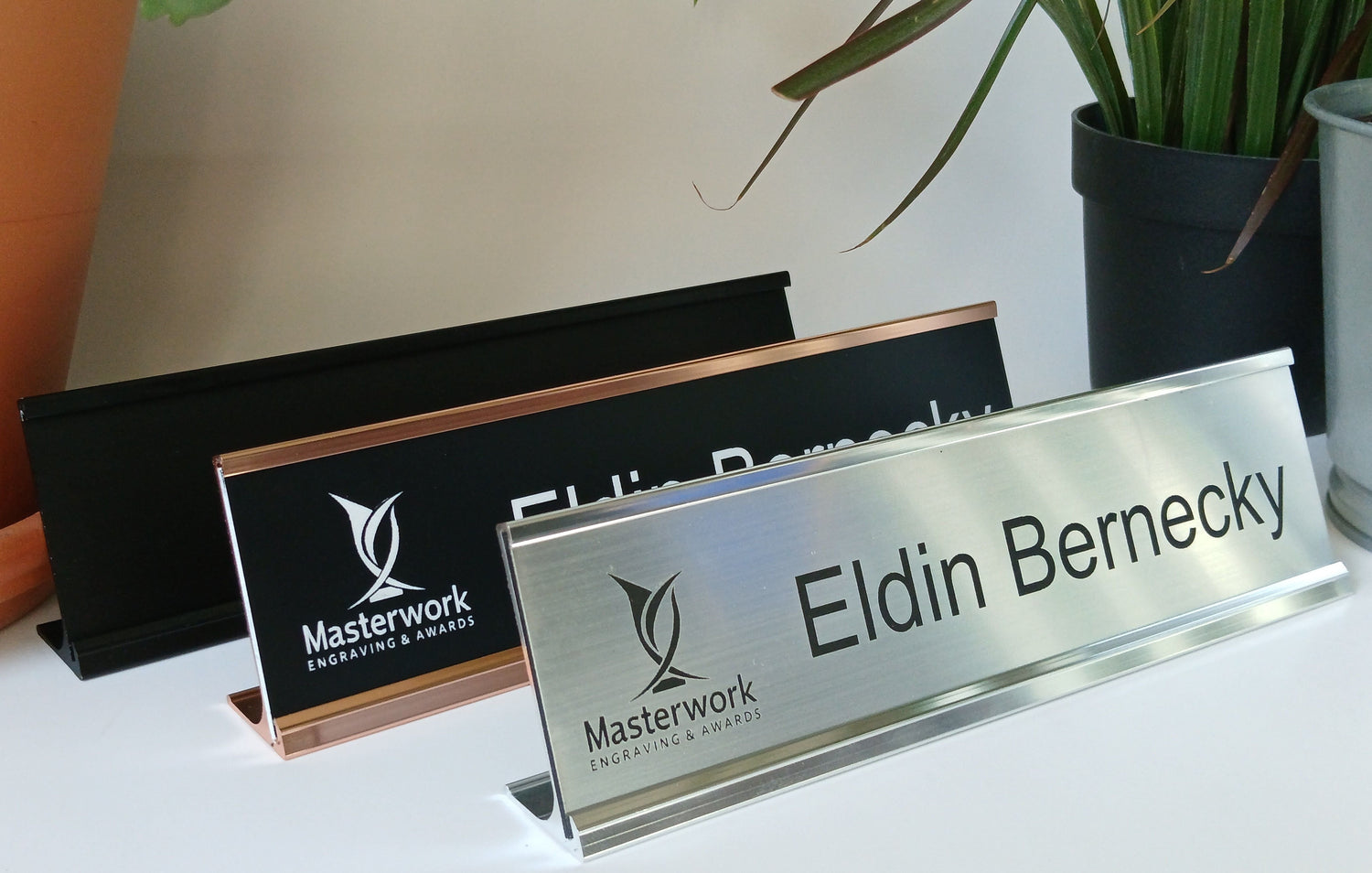 Office desk nameplates with engraved plastic (lamacoid) inserts.