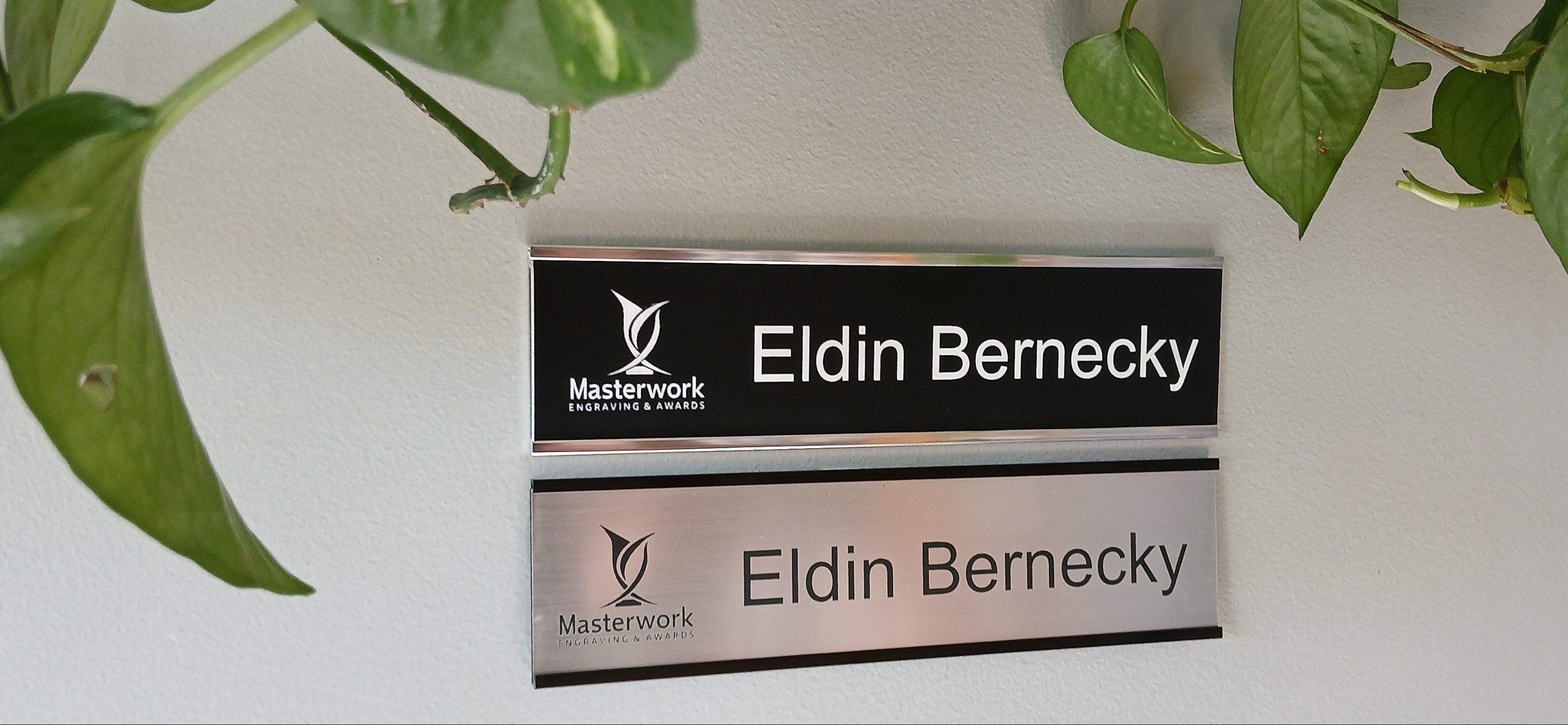 Office wall nameplates with engraved plastic (lamacoid) inserts.